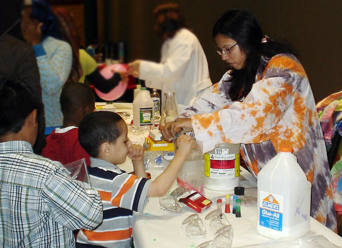 Muna Nahar '09 assists children with the slime-making experiment. The event was held at the Connecticut Convention Center in Hartford, Conn. 