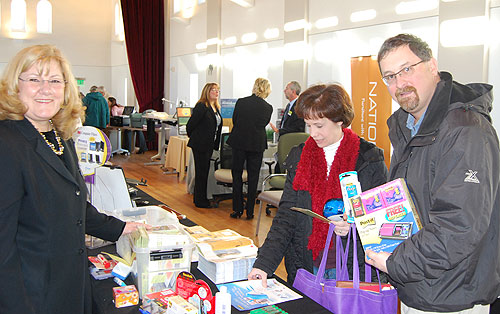 Margaret Liebig, left, a sales executive with 3M Office Supplies Division in Parsippany, NJ, speaks to Dianne Meredith, lab coordinator for the Biology Department, and Jeff Gilarde, director of scientific imaging, about 3M's paper products. All attendees were given a recycled-material bag to tote their samples in.