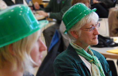 Donning St. Patrick's attire, Suzanne O'Connell, associate professor and chair of the Earth and Environmental Sciences Department, director of the Service Learning Center, enjoys the hour-long performance. 