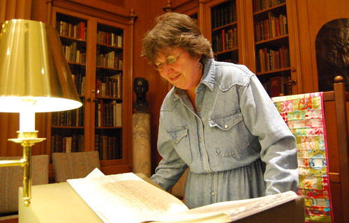 Margery May, acquisitions administrator, browses the pages of "The elements of a poem" by Susan Stewart and Enid Mark. 