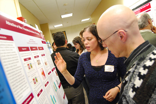 Sarah Edelman ’09 explains her research to Scott Plous, professor of psychology, during the Department of Psychology Research Poster Presentation April 23 in Judd Hall. Edelman’s study, "The Relative Contributions of Physical Attractiveness and Prosocial Behavior in Preschool Friendship Choices" explores how children ages 3 and 4 chose friends in school and internalize gender schemas early on. 