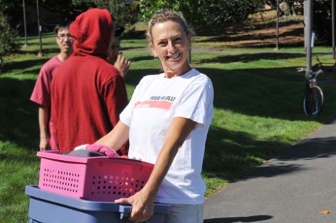 Kari Weil, visiting professor of letters, and wife of Wesleyan President Michael Roth, helps Class of 2013 members carry in their belongings.