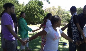Pictured in the green shirt, Renee Johnson-Thornton, dean of Diversity and Student Engagement, associate coordinator of the MMUF Program, participates in "a human knot" in Cape Town. 