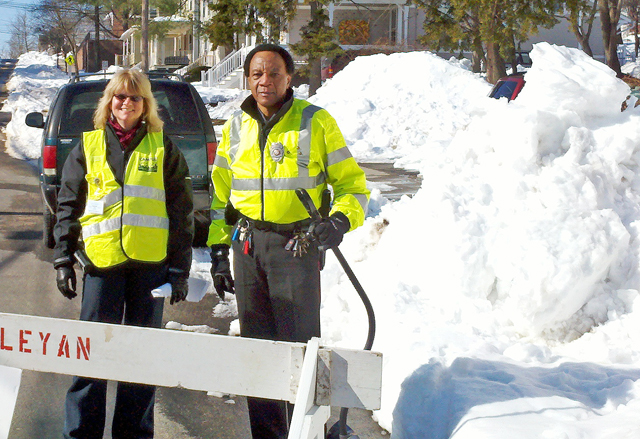 C-CERT members Stacy Baldwin, construction project coordinator, and Simon Bostick, public safety officer, assist with parking on Lawn Avenue. 