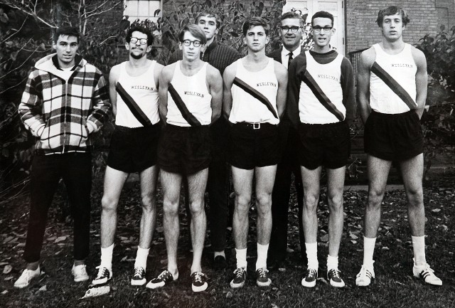 Wesleyan alumni Bill Rodgers '70 (second from left with dark glasses) and Amby Burfoot '68 (second from the right), pictured in this 1967 men's cross country team photo, will reunite April 6 for a half marathon. The team's former coach, Elmer Swanson, is pictured looking over Burfoot's shoulder. Jeff Galloway '67 also will run the race. 