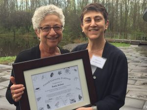 Sonia Sultan, right, is presented with a plaque by Ellen Harrison, wife of the influential biologist Rick Harrison after whom the Harrison Keynote Lecture is named. Sultan presented the lecture at Cornell's annual Evo Day symposium in May.
