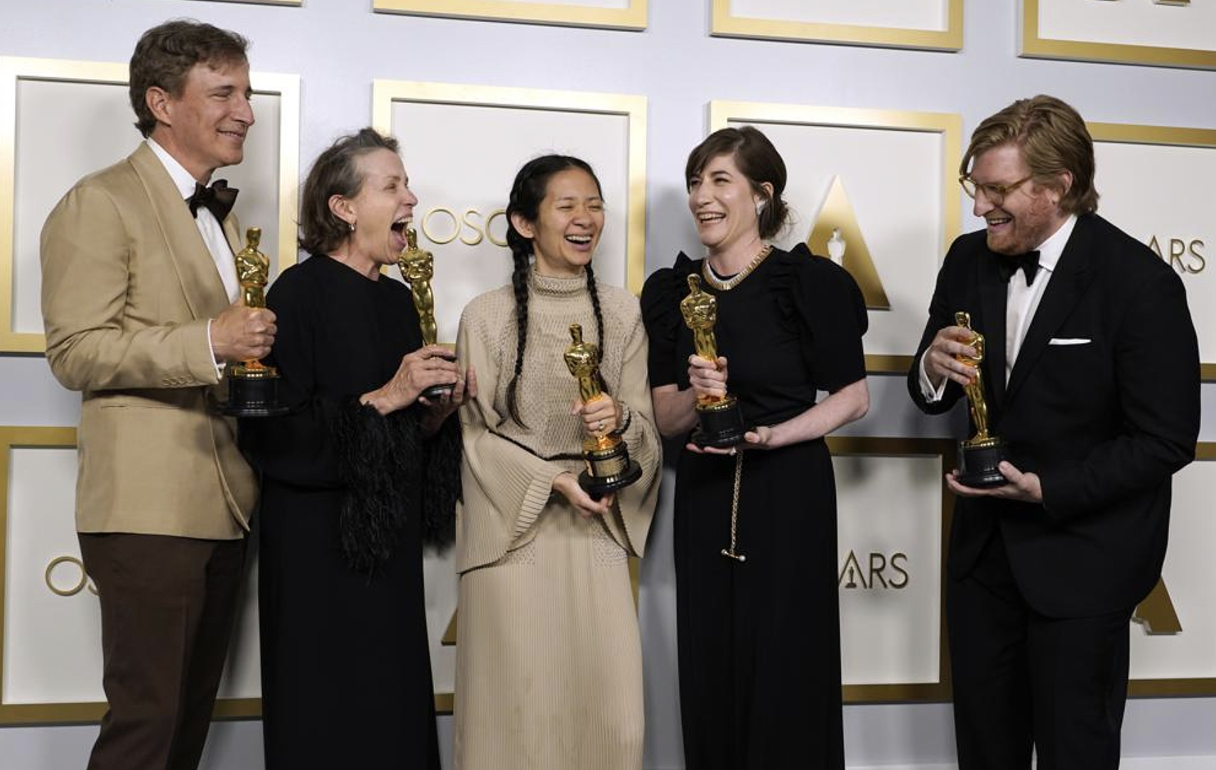 Producers Peter Spears, from left, Frances McDormand, Chloe Zhao, Mollye Asher and Dan Janvey, winners of the award for best picture for "Nomadland," pose in the press room at the Oscars on Sunday, April 25, 2021, at Union Station in Los Angeles. (AP Photo/Chris Pizzello, Pool)