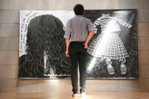 Wendy Ewald's "Towards a Promised Land" looms large in Zilkha's main gallery. Krieger, '11 looks on. (Photos by Intisar Abioto '09)