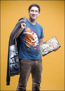 Dan Lachman '09 sports his t-shirt and laptop skin designs. (Photo by Keith Barraclough Photography)
