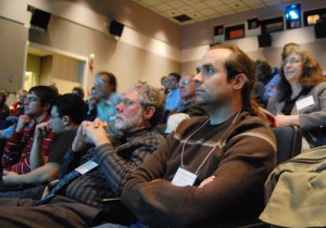 At left, Bill Herbst, the John Monroe Van Vleck Professor of Astronomy, and Roy Kilgard, assistant astronomer, listen to a student's presentation during the symposium. (Photos by Olivia Bartlett)