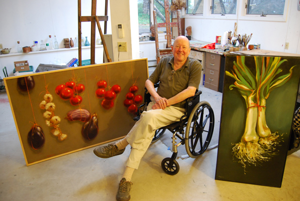 John Frazer, professor of art, emeritus, taught drawing and film classes consecutively at Wesleyan from 1959 to 2001. He's pictured here in his Middletown studio with two of his own paintings. (Photo by Olivia Bartlett)