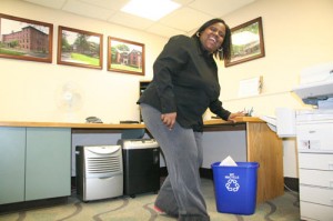 Dawn Brown, area coordinator in Residential Life, tosses office waste into her recycle bin. 