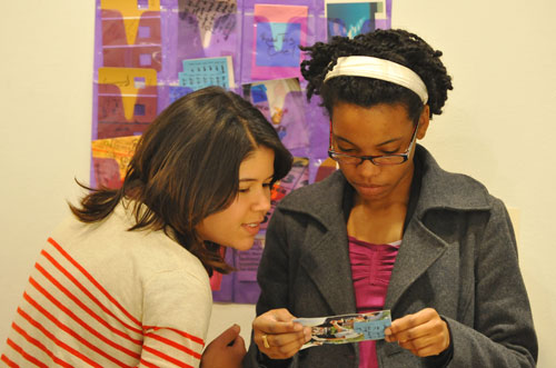 At left, Priya Ghosh '09, one of the student curators who started the show three years ago, and Karimah Nichols '09 look over art together. 