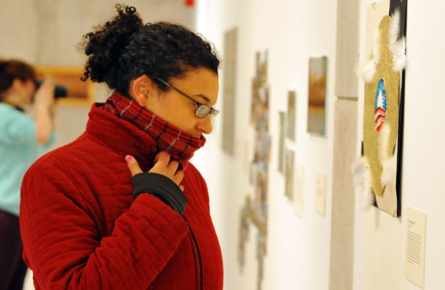 Carolyn Ariori '09 looks over artwork during the show's grand opening. 