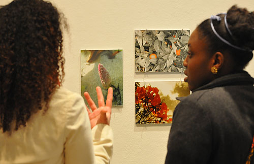 MelanieNelson '09, at left, talks about her photographs titled "Naturaleza Interior" to Marsha Jean-Charles '11.