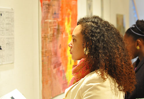 Melanie Nelson '09, also an artist in the show, looks at her peers' artwork. 