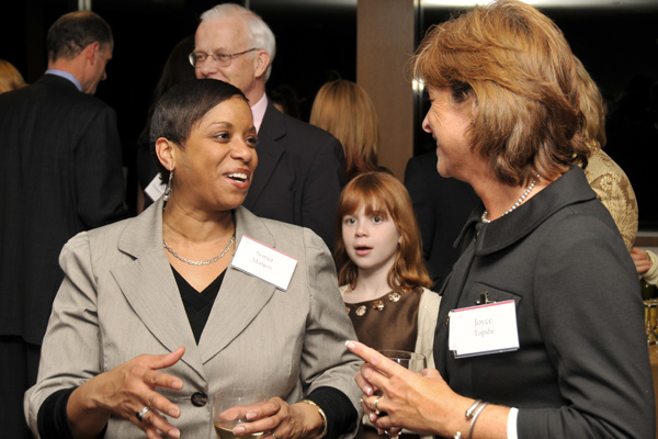Sonia Mañjon, vice president for diversity and strategic partnerships, speaks with Joyce Topshe, associate vice presiddent for facilities, during the Daniel Family Commons dedication. Pictured in back, center, is India Daniel. 