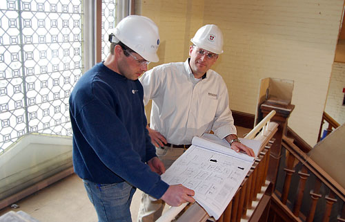 At left, Scott Martin, superintendent of PAC Group LLC in North Haven, Conn. discusses floor plans with Alan Rubacha, construction services consultant, inside the former Davenport Campus Center on March 16.The building is undergoing an interior remodeling project and will re-open as The Allbritton Center for the Study of Public Life for the Fall 2009 semester. 