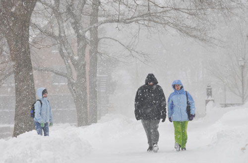 Bundled in warm layers, students weather the snow and wind on campus. 