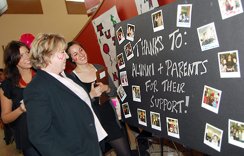 University Relations held a "Tuition Transition" celebration March 27 in Usdan University Center to thank alumni and parent donors for their financial support. Pictured, from left, Sarah Bell '09, Pam Vasiliou, director of the Wesleyan Fund, and Katie Borfshever '09 look over a poster on display.