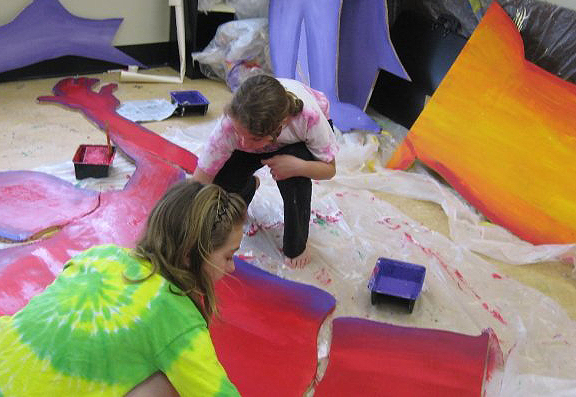 Children work on sections of the mural inside the GSAC.