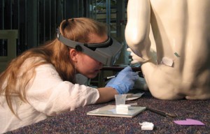 Wesleyan University Summer Experience Grant recipient Eve Mayberger '10 works on consolidating cracking the glazing on an earthenware statue during her internship at the Smithsonian American Art Museum this summer. 