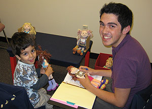 Christian Hoyos ’11 works with a 3-year-old during an experiment on sharing behavior during a summer internship at the Social Cognitive Development Lab at Yale University. 