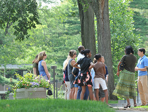 XX, at far right, speaks about Olin Memorial Library to a tour group July 30. 