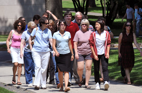 XX, center in blue shirt, leads a tour down College Row. All events begin at the Stewart M. Reid House. No pre-registration is necessary for campus tours or group information sessions.