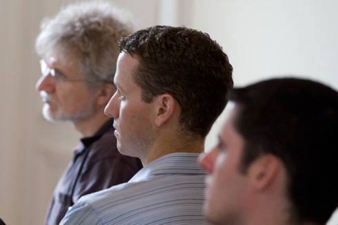 At left, Michael Weir, director of the Hughes Program in the Life Sciences, professor of biology, and in center, Brian Northrop, assistant professor of chemistry, listen to Olson's presentation.