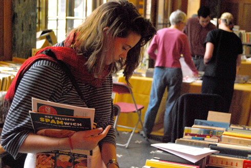 Alice Goldsmith '10 scans the selection at the Olin book sale. Most hardcover books were $2 and paperback books were $1. 