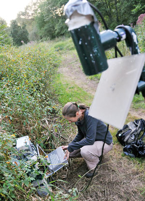 Biology Ph.D. candidate Kate Miller records echolocation calls of bats at one of four study sites along Middletown's Coginchaug River. Miller hopes to identify which types of stream habitats have the most activity, and uncover critical habitats in Connecticut.  (Photos by Olivia Bartlett Drake)