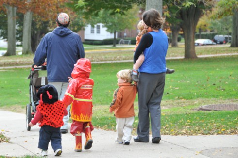 Ladybug Aria and fireman Orr walk behind their father, Rabbi David Leipziger Teva, director of Religious and Spiritual Life and University Jewish Chaplain. At right, Catherine Crimmins Lechowicz walks in the parade with her twin boys Charlie (walking) and JP. 