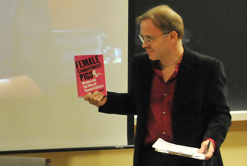Joel Pfister, the Kenan Professor of the Humanities and chair of the English Department, holds a copy of Levy's book, <em>Female Chauvinist Pigs</em>. Pfister introduced the speakers and moderated the event. 