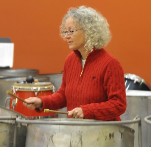 Cheryl-Ann Hagner, director of the Office of University Events and Scheduling, performs on a steel drum with the staff band. 