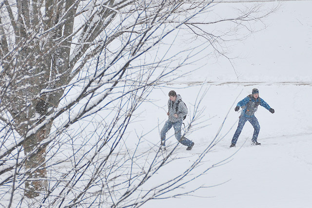 Students run and slide down the College Row sidewalks en route to class. 