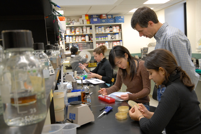 At right, Scott Holmes, associate professor of molecular biology and biochemistry, received a three-year grant to support his research gene expression. His lab uses a budding yeast for the studies. 
