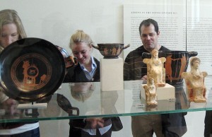 Visiting international student Anna Huber and Jorge Bravo, visiting assistant professor of classical studies, look at a display case of red-figure vases and small votive figurines from classical Athens.