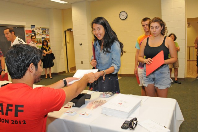 Claudia Von Nostitz '16 picks up her WesCard on Student Arrival Day from student worker Ali Shajrawi '15. "I'm betraying my class by saying this but you have an awesome class. 2016 might be the best class on campus," Shajrawi says.