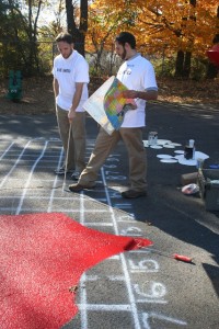 Residential Life area coordinators Brian Nangle and Daniel LaBonte paint a map of the United States on the school's playground. 
