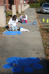 Tessa Young '13 and Roseann Sillasen, associate director and project manager of Physical Plant - Facilities, work on additional paw paintings.  
