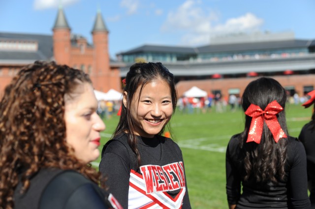 In center, Isabella Sihui Zhu '14 cheered on the Cardinals during the Homecoming football game Oct. 20. The Cardinals lost to Amherst 17-9. 
