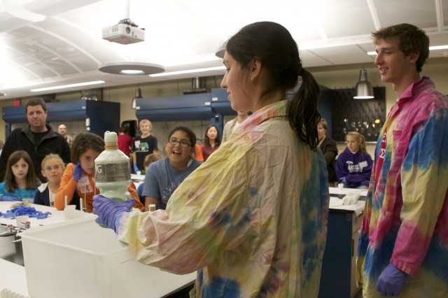 Rachel Olfson '14 and Bennett Sluis '14 make "Elephant's toothpaste" for Science Day goers. 