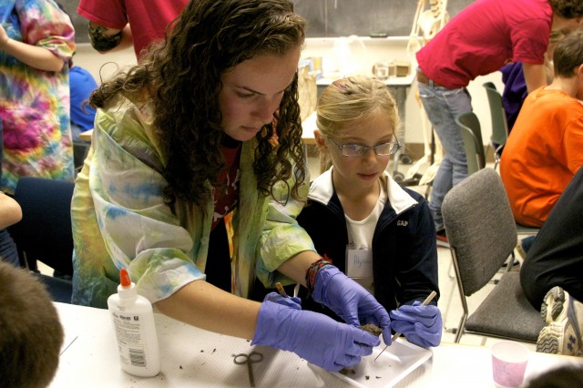 Emily Berman '13 helps Science Day goer Alyssa dissect her owl pellet. The semi-annual afternoon of science activities are designed for the whole family.