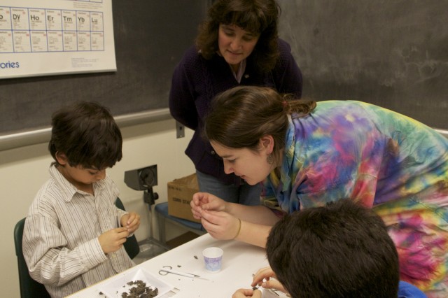 Wesleyan students enrolled in the outreach course taught science lessons and offered hands-on demonstrations. Pictured is Eliza Forman '13 aiding in another careful owl pellet dissection.