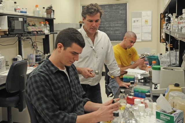 Jeff Arace '12, pictured in the foreground, and Ph.D candidate James Arnone, pictured in the back, work on transcriptional regulation of paired genes involved in ribosome biogenesis with their advisor, Michael McAlear, chair and associate professor of molecular biology and biochemistry, in center. Adam Robbins-Pianka BA ’08, MA ’10 and Sara Kass-Gergi ’12 also work in the McAlear Lab.   