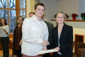Sociology major Evan Okun accepts his Phi Beta Kappa papers from Class Dean Louise Brown, PBK chapter secretary and marshall. Okun teaches a class at the juvenile detention in Middletown, which examines literary technique and societal inequality through rap songs.