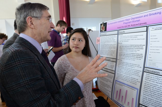 Lauren Seo '14 speaks to a guest judge about her research on "The Association between Major Depression and Smoking in Pregnant Women." 