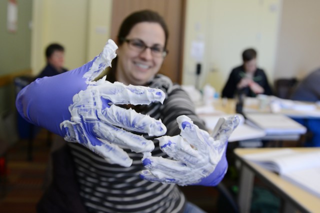 If this shaving cream was a contaminate, how can you remove your medical gloves without getting the contaminate on your own skin? C-CERT trainee Gretchen Streiff, assistant director of student activities and leadership development, gives it a try. 