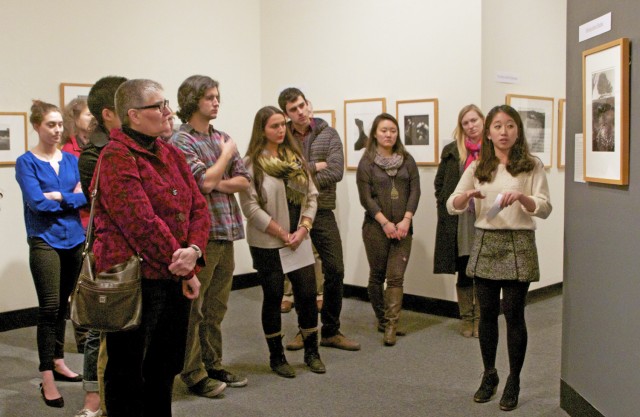 The Davison Art Center's exhibit, "(Re)viewing Bodies: Selected American Photographs, 1930-2000," opened on Feb. 7 in the DAC gallery. The show is curated by students who took the course ARHA 360, Museum Studies, taught in fall 2012 by Clare Rogan, curator of the Davison Art Center. Hyunjin Chelsey Cho ’13, pictured, is one of the student curators who helped opening attendees navigate the gallery.